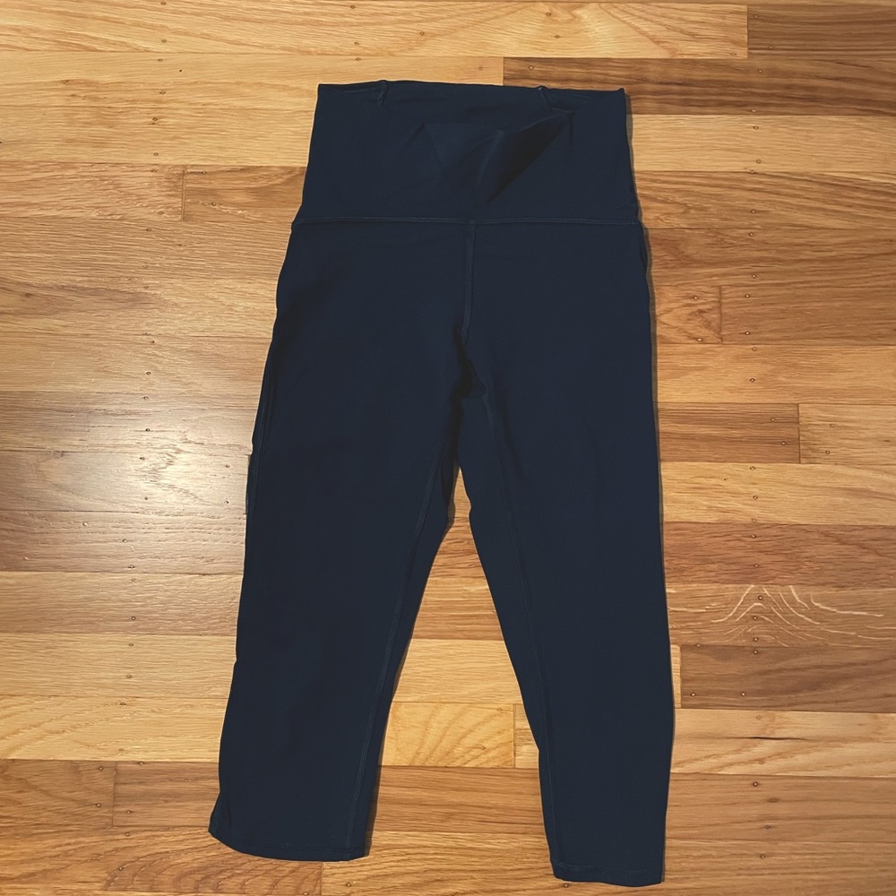 Navy Blue Lululemon leggings, cropped with mesh side strip.